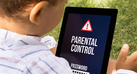 a kid looking at a tablet that has a parental control warning up.