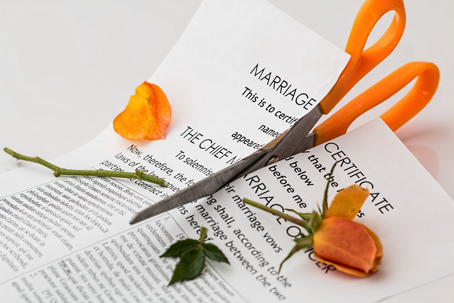 scissors cutting up a marriage certificate