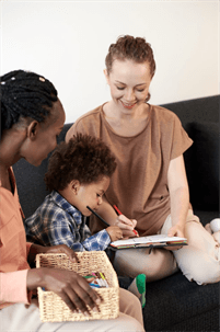 a child visiting with two women.