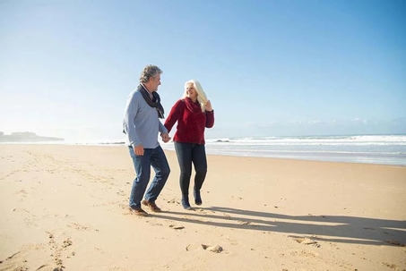 couple holding hands on the beach