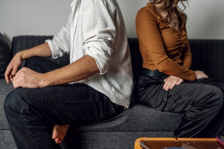 Spouses sitting back to back with each other