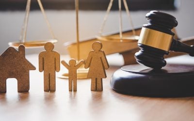 Scales of justice and a wooden family figures
