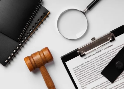Notebook, gavel and magnifying glass