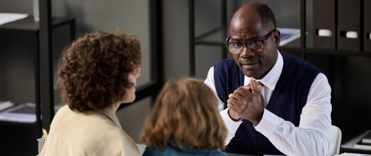 a man talking with two children